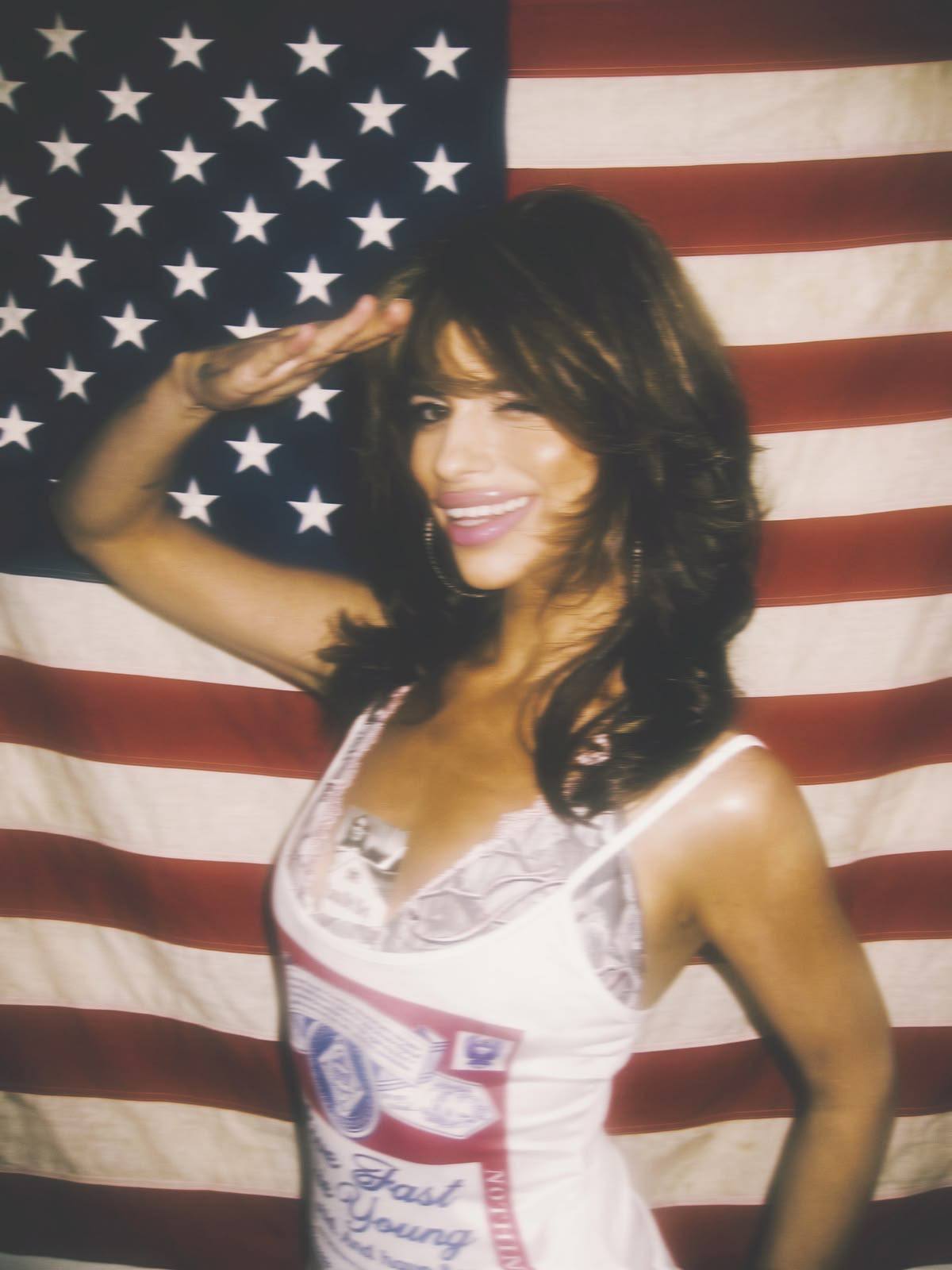 Patriot saluting in front of the American flag